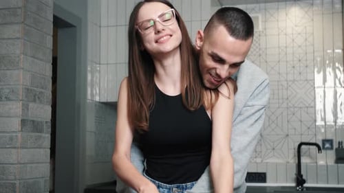 Loving Couple Cooking Together in Modern Kitchen