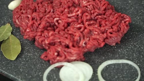 Fresh Ground Beef Rotates on Cutting Board