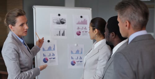 Business Team Analyzes Data During Presentation