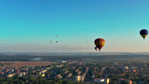 Hot Air Balloons Ascend over City, Aerial View