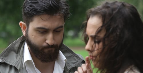 Serious Man and Woman Talking in Green Park