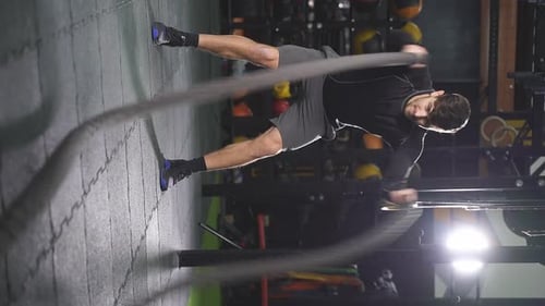 Fit Athlete Doing Battle Rope Exercise at Gym