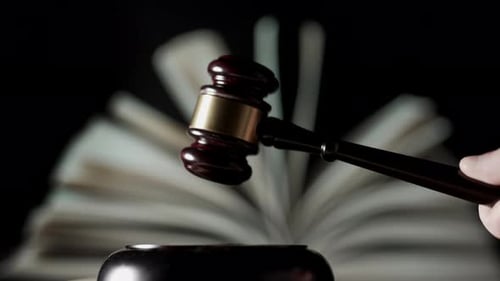 Judge is Hitting Gavel Off a Block in Courtroom