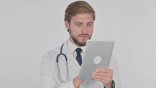 Young Adult Doctor Uses Tablet in Clinic