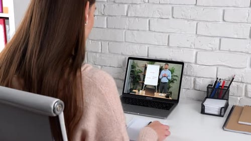 Man Coach in Laptop Screen Stands Near Flip Chart Greets Tells Teaches Student