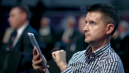 Using Notepad Conference Auditorium Crowd Viewer. Business Men Type Finger Pad