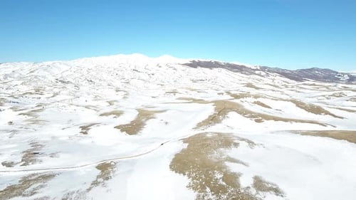 Car Passes Through Snowy Mountains
