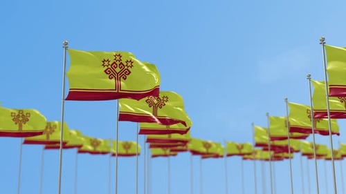 Waving Flags with Abstract Geometric Pattern Against Clear Blue Sky