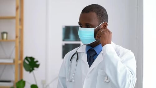 Doctor Mask Portrait Young Male Takes Off Protective Mask and Poses While Working at Modern Clinic