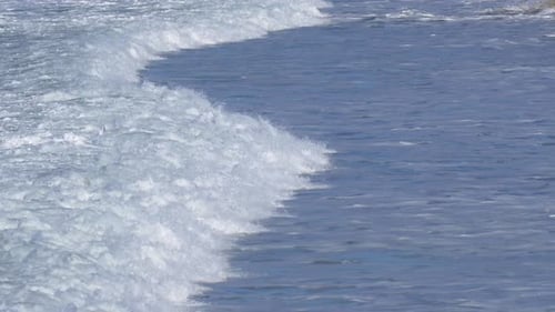 Waves break in surf line.