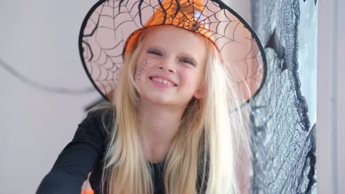 Girl Wearing Witch Costume Smiles at Camera