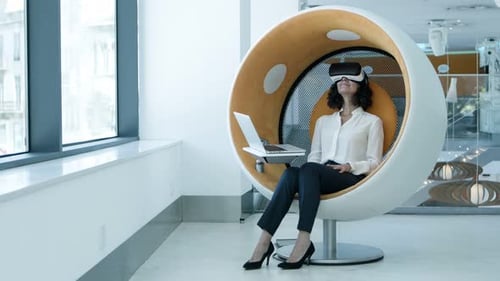 Woman Using VR Headset in Modern Office Chair