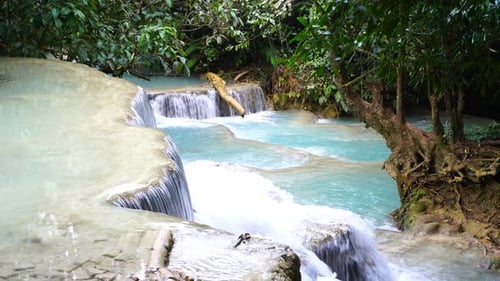 Tropical Waterfall Cascading Through Lush Green Landscape