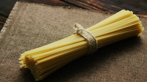 Raw Spaghetti Tied with Twine on Burlap