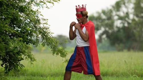 Man in Costume Mock Boxing in a Rural Field