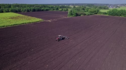 Tractor Preparing Soil for Planting New Crop Next Season