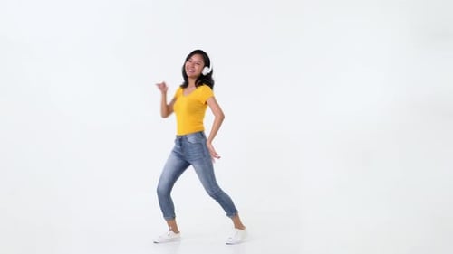 Cheerful Woman Dancing with Headphones in Studio