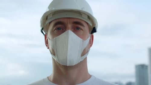 Adult Wearing Hard Hat and Mask Close Up