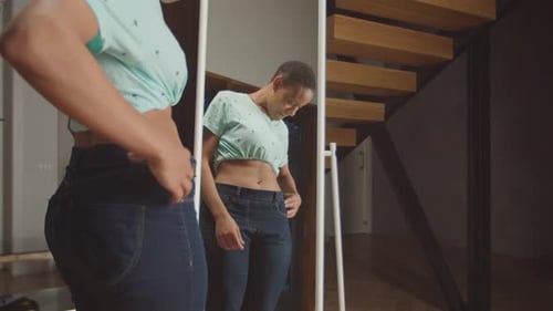 Woman is Happy Jeans are Too Big