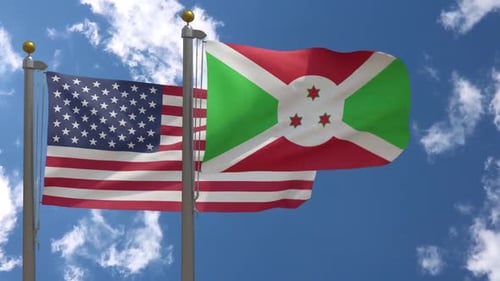 United States and Burundi National Flags Waving Against Blue Sky