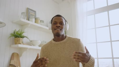 Man Listening to Music and Dancing at Home