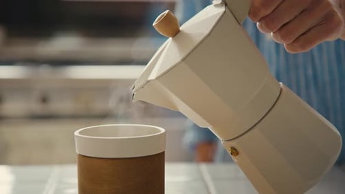 Pouring Fresh Coffee from Moka Pot into Cup