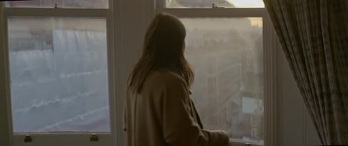 Woman opening window in apartment in the morning