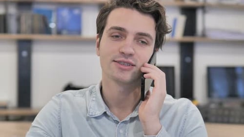 Portrait of Creative Man Talking on Phone in Office