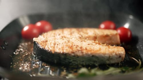 A Salmon Fillets on a Grill Plate with Herbs and Vegetables