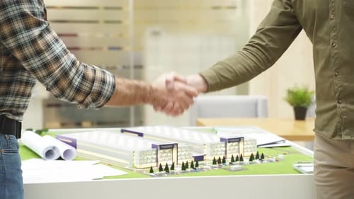 Nahaufnahme von Ingenieuren beim Händeschütteln während der Teamarbeit im Büro