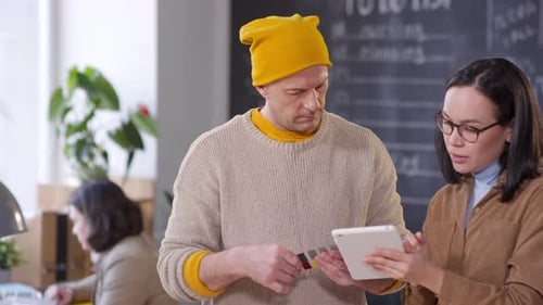 Coworkers Collaborating with Tablet and Color Swatches