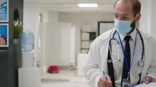 African American Woman Talking to Physician at Hospital Reception