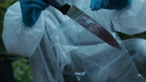 Forensic Investigator Collecting Crime Scene Knife Evidence
