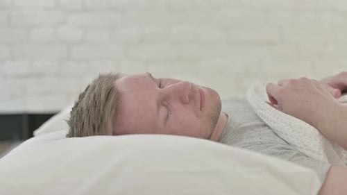Man Sleeping Peacefully in Bed at Home