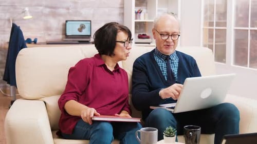 Senior Couple Using Laptop Together at Home
