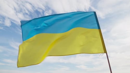 Ukrainian Flag Waving Against Blue Sky