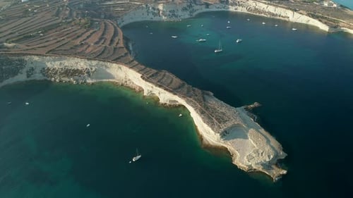 Mediterranean Headland of Malta Island in Sunset Light with Turquoise Blue Water, Aerial Slide Right