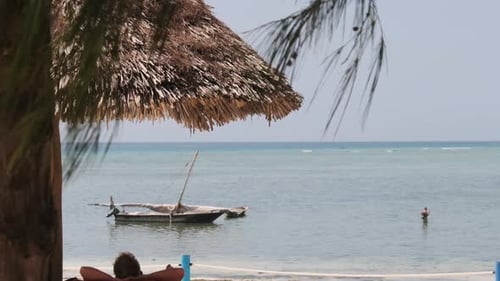 Thatched Umbrellas on the Sandy Beach By the Ocean at Low Tide Zanzibar Africa