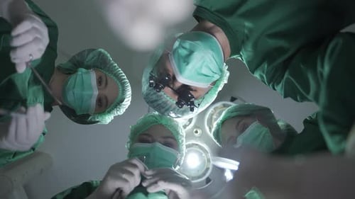 Medical Surgeons Team Performing Surgical Operation in Modern Operating medical Room at hospital.