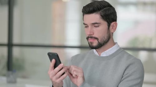 Porträt eines jungen Mannes mit Smartphone