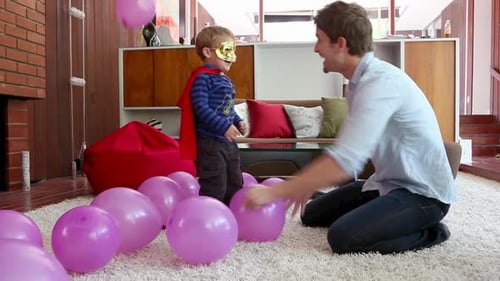 Father and Son Play with Balloons at Home