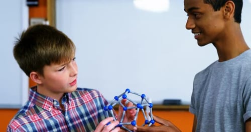 School students experimenting molecule model in laboratory