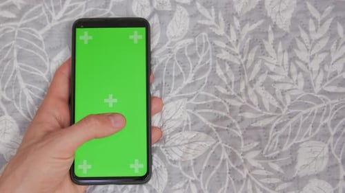 Hand Swiping Phone with Green Screen Close Up