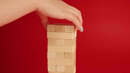 Stacking Wooden Blocks Higher to Build a Tower