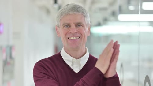 Smiling Man in Office Clapping