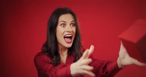 Woman Receives Gift and Reacts with Happiness