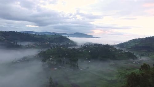 Aerial view of villages on hills covered by clouds