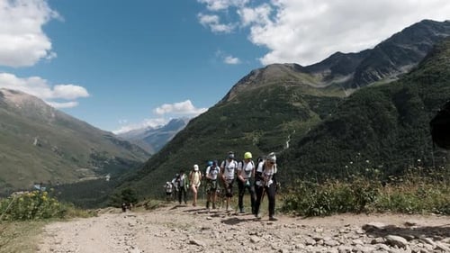 Aerial view a group of hikers walking on a stony trail