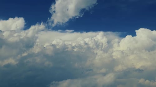 Fluffy Clouds Drifting Across a Blue Sky