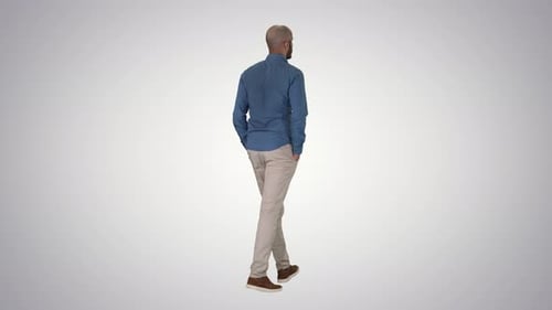 Man Walks Confidently with Hands in Pockets